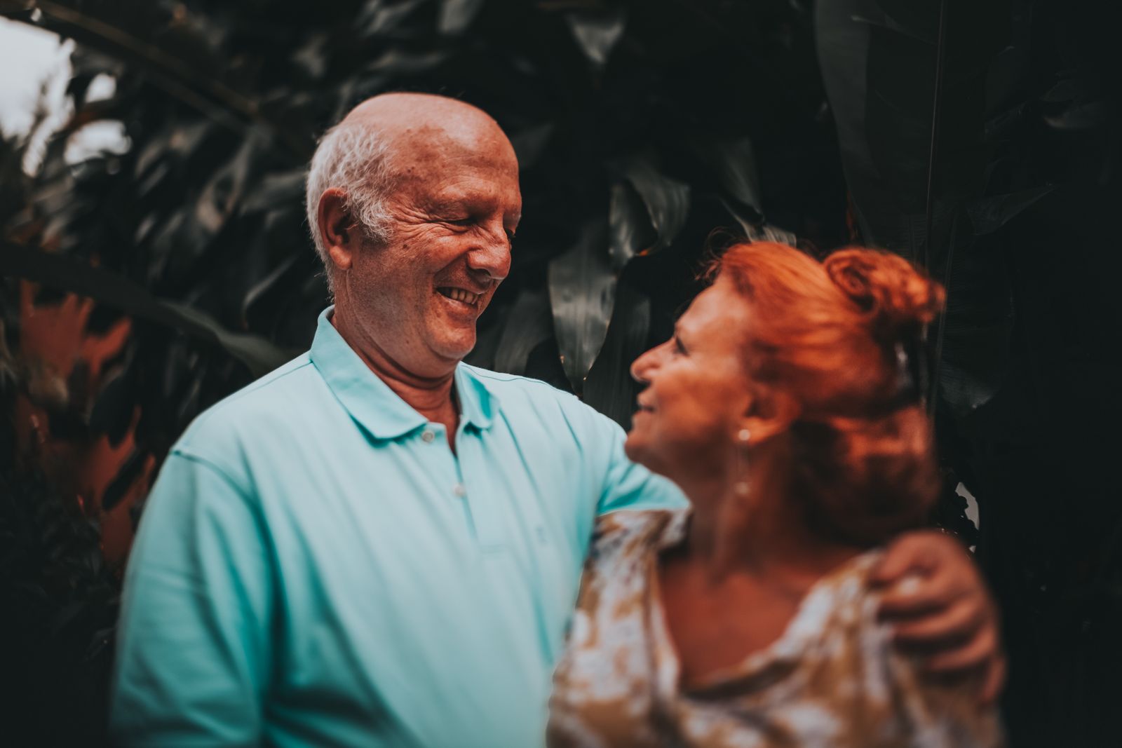 An older couple laughing together outdoors