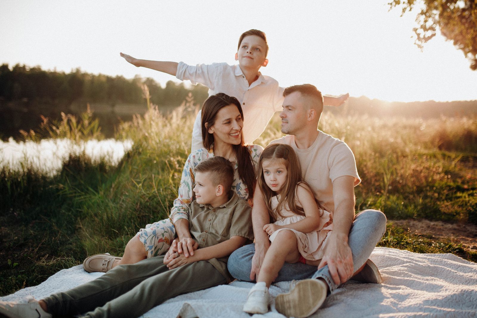A family enjoying a picnic together in a sunlit meadow